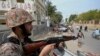 Paramilitary soldiers stand guard on the side of a road for security, ahead of Feb. 8 general elections, in Karachi, Pakistan, Feb. 7, 2024.