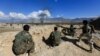 FILE - Afghan security forces take position during a gun battle between Taliban and Afghan security forces in Laghman province, Afghanistan, March 1, 2017. 