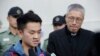 Chan Tong-kai, left, talks to the media as he is released from prison in Hong Kong, Oct. 23, 2019. 