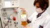 FILE - A nurse holds a bag of plasma from a recovered COVID-19 donor, at the Belgian Red Cross blood collection center in Brussels, Belgium, Oct. 27, 2020. 