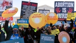 FILE - Protesters for and against abortion rights demonstrate in front of the U.S. Supreme Court, Dec. 1, 2021, in Washington.