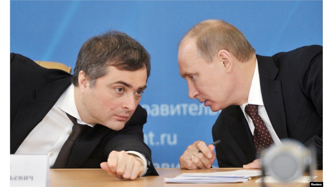 FILE - Russian Prime Minister Vladimir Putin, right, talks with Deputy Prime Minister Vladislav Surkov as they attend a meeting in Kurgan, Feb. 13, 2012.