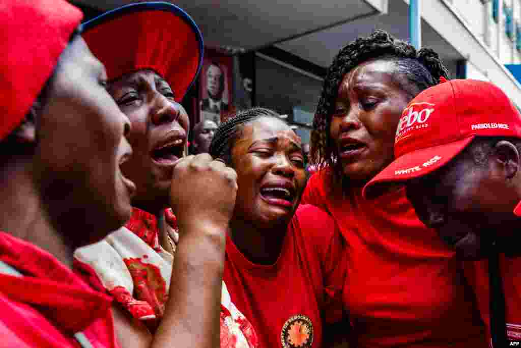 Supporters of the Zimbabwe opposition party Movement for Democratic Change (MDC) cry outside Harvest House, the party headquarters, in Harare following the death of the veteran leader Morgan Tsvangirai. Tsvangirai died of cancer at the age of 65.