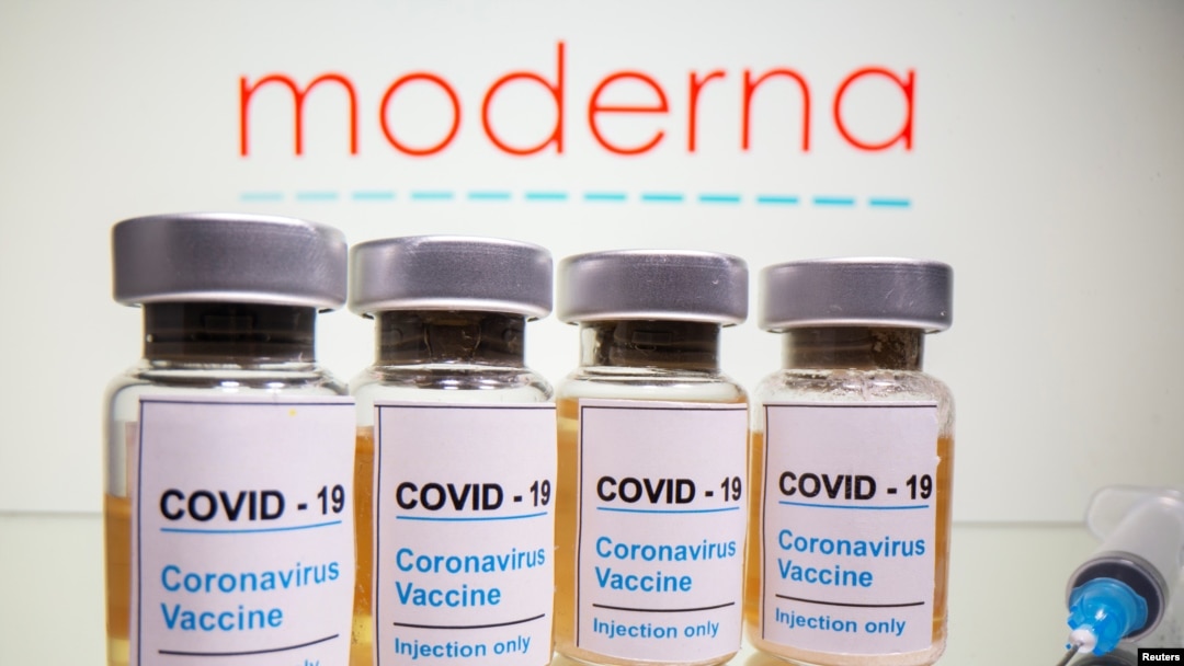 Vials with a sticker reading, "COVID-19 / Coronavirus vaccine / Injection only" and a medical syringe are seen in front of a displayed Moderna logo in this illustration taken October 31, 2020. REUTERS/Dado Ruvic/Illustration