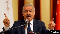 FILE - Palestinian Prime Minister Mohammad Shtayyeh gestures as he speaks during a workshop on cooperation between Palestinians and East Asian countries, in Jericho in the Israeli-occupied West Bank, July 3, 2019.