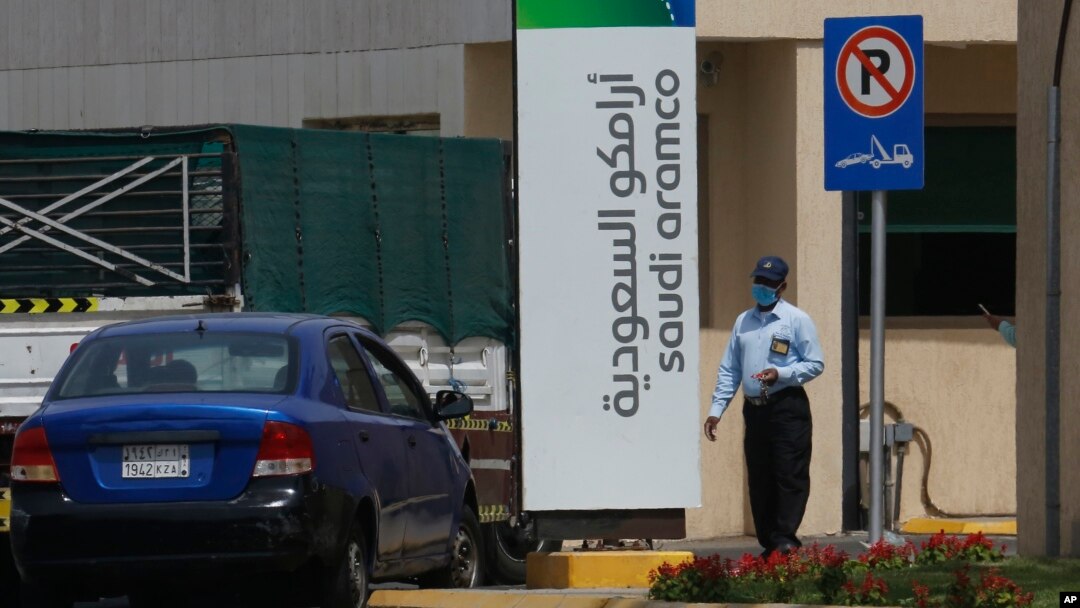 A security person wears a mask as he checks a vehicle entering a compound for Saudi Aramco in Jiddah, Saudi Arabia, Monday, March 9, 2020.