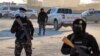 Members of the Syrian Democratic Forces (SDF) deploy around Ghweiran prison in Syria's northeastern city of Hasakah, Jan. 25, 2022.