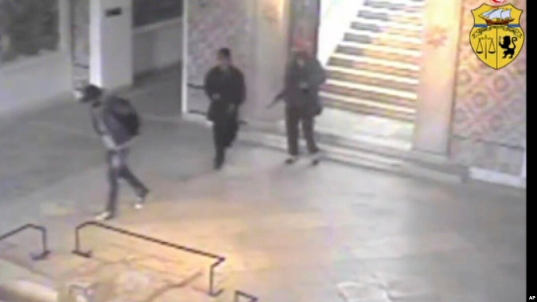 FILE - In this frame made from CCTV and released by the Tunisian government, two gunmen and third unidentified man can be seen inside the Bardo museum in Tunis, March 18, 2015. 