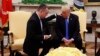 President Donald Trump prays with American Pastor Andrew Brunson in the Oval Office of the White House, Oct. 13, 2018, in Washington. Brunson returned to the U.S. after he was freed Friday, having been detained for nearly two years in Turkey.