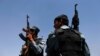 Afghan policemen keep watch as election commission workers move ballot boxes and election material to a polling station in Kabul, June 13, 2014.
