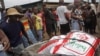 A man, left, renting out his wheelbarrow moves food goods for people in the West Point area that have been hardest hit by the Ebola virus spreading in Monrovia, Liberia, Monday, Aug. 25, 2014. A Liberian doctor who was among three Africans to receive a