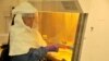 FILE - A medical worker from the U.S. Centers for Disease Control and Prevention, and researchers who are working on the Ebola outbreak in Uganda, at their laboratory in Entebbe, 42 kilometers from the capital Kampala, Aug. 2, 2012.