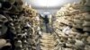 FILE - A Zimbabwe National Parks official inspects the country's ivory stockpile at parks headquarters in Harare, June 2, 2016. Ugandan authorities on Jan. 31, 2019, announced the confiscation of about 750 pieces of ivory plus pangolin scales brought in from South Sudan. 