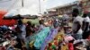 FILE - Pedestrians shop for clothes at Mokolo Market in Yaounde, Cameroon.