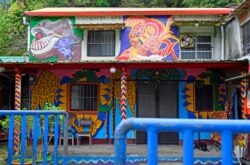 A dog sleeps, March 30, 2019, in the courtyard of a house painted by Hakka graffiti artist Wu Tsun-hsien in the Taiwanese village of Ruan Chiao.