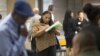 FILE - Malana Long fills out a job application during a job fair for the homeless at the Los Angeles Mission in the Skid Row area of Los Angeles, California, June 4, 2015. The number of Americans filing new claims for unemployment benefits fell more than expected last week, pointing to a tightening labor market. 