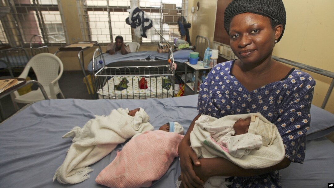 Mabel Ighedosa, 30, sits with her newborn triplets Isaac, Treasure and Samuel in a ward of the Lagos Island Maternity Hospital in Lagos, Nigeria, October 31, 2011.