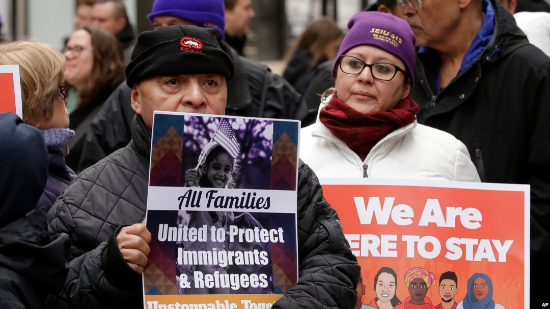 Protesters display placards during a rally called "We Will Persist" in Boston, Feb. 21, 2017.