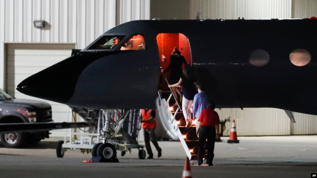 Visitors and medical personnel enter a transport plane carrying Otto Warmbier, before he is transferred to an ambulance at Lunken regional airport, June 13, 2017, in Cincinnati, Ohio.