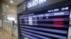 An electronic signboard shows that flights from Tokyo's Haneda airport scheduled were canceled near the self check-in system at Gimpo Airport in Seoul, South Korea, Monday, March 9, 2020.
