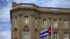 FILE - The Cuban national flag is seen raised over their embassy in Washington, July 20, 2015. 