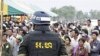A Cambodian military policeman stands watch during the ground breaking ceremony of a Chinese funded road at Koun Damrey village, Banteay Meanchey province, about 15 kilometers (9 miles) east of Cambodia's border with Thailand, February 15, 2011