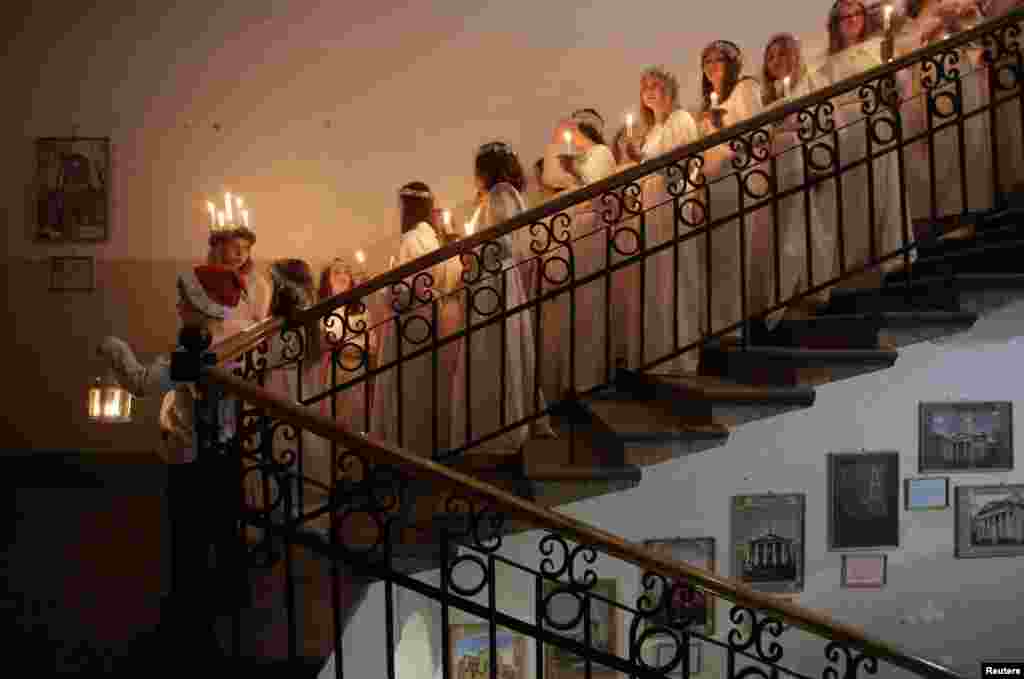 Youths wait to perform during the celebration of St. Lucia&#39;s Day at the Swedish Evangelical and Lutheran church of St. Katarina in St. Petersburg, Russia, Dec. 13, 2017.