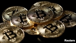A collection of Bitcoin (virtual currency) tokens are displayed in this illustration taken Dec. 8, 2017.
