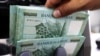 FILE - Lebanese pound banknotes are seen at a currency exchange shop in Beirut, Lebanon, June 15, 2020. 