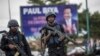 FILE - Members of Cameroon's security forces patrol in the Southwest province capital Buea, Oct. 3, 2018.
