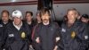 FILE - This Nov. 16, 2010 photo, provided by U.S. Drug Enforcement Administration (DEA), shows Viktor Bout, center, being led by DEA officers off a flight in New York before Bout's 2012 conviction in U.S. courts for illegal arms trafficking .