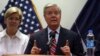 FILE - U.S. Senator Lindsey Graham speaks during a press conference at the Resolute Support headquarters in Kabul, Afghanistan, July 4, 2017. Senator Elizabeth Warren, left, also made the trip.