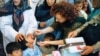 FILE - Ellyn Ogden, USAID's worldwide polio eradication coordinator, immunizes a child during a festive kick-off event for a polio vaccination campaign in Kabul, Afghanistan.