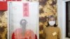 A Taiwanese voter stands at a polling booth during the general elections in Kaohsiung, Taiwan, Jan. 11, 2020. 