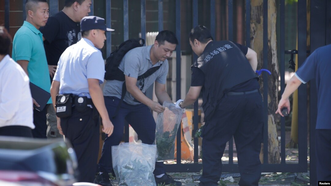 Police work at the scene of explosion after the blast outside the U.S. embassy in Beijing, China, July 26, 2018.