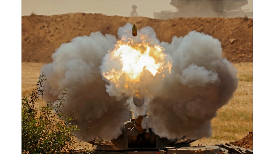 Israeli soldiers fire a 155mm self-propelled howitzer towards the Gaza Strip from their position along the border in the southern Israeli city of Sderot.