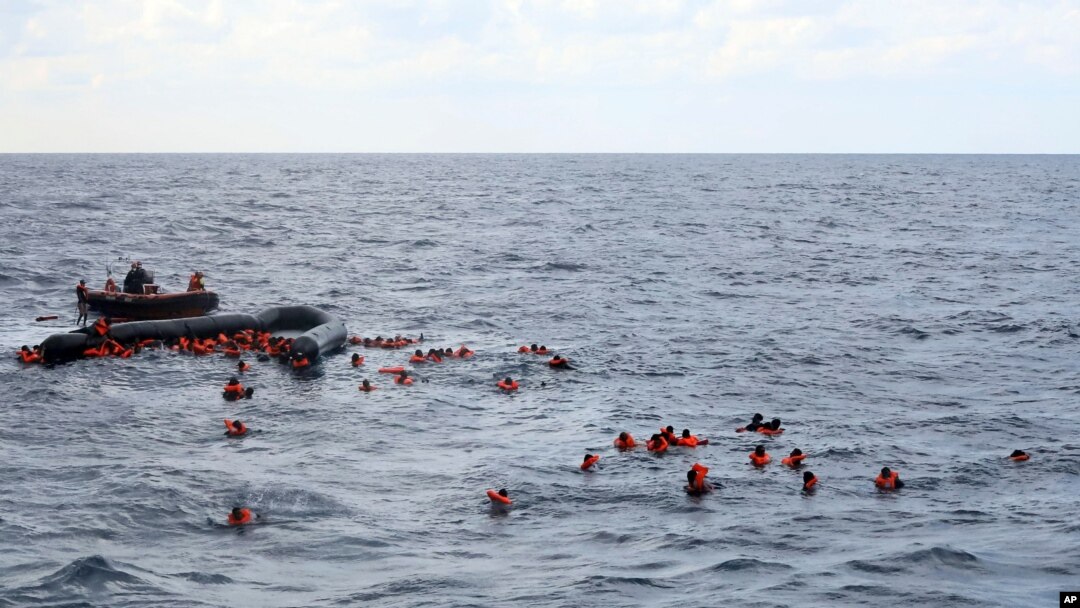File - Refugees and migrants are rescued by members of the Spanish NGO Proactiva Open Arms, after leaving Libya trying to reach European soil aboard an overcrowded rubber boat in the Mediterranean sea, Nov. 11, 2020.