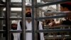 FILE - An Afghan prisoner waits in line for his release from Parwan Detention Facility, Mar. 25, 2013.