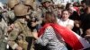 Anti-government protesters scuffle with Lebanese army soldiers in the town of Zouk Mosbeh, north of Beirut, Lebanon, Nov. 5, 2019.