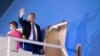 U.S. President Donald Trump and first lady Melania Trump wave as they board Air Force One upon departure from Indian Air Force Palam airport in New Delhi, India, Feb. 25, 2020.
