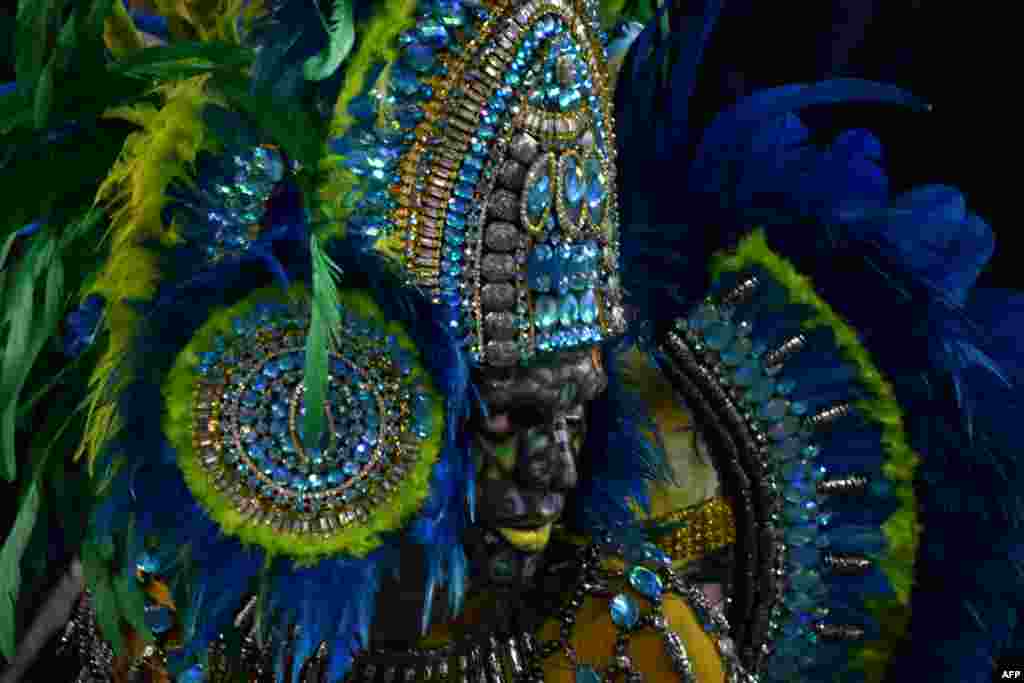A reveler of the Unidos de Vila Maria samba school performs during the second night of carnival at the city's Sambadrome in Sao Paulo, Brazil.