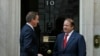 Britain's Prime Minister David Cameron (L) greets his Pakistani counterpart Nawaz Sharif as he arrives for their trilateral meeting with Afghan President Hamid Karzai, at Number 10 Downing Street in London, Oct. 29, 2013.