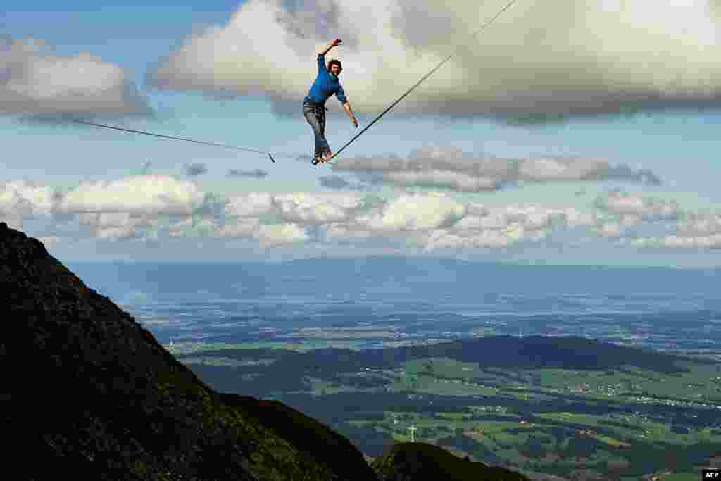 Daniel Laruelle of South Africa walks on the line during the Highline Extreme event in Moleson peak, western Switzerland, Sept.15, 2017. 