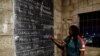 An election worker counts votes during the presidential election in Yaounde, Cameroon, Oct. 7, 2018.