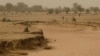 In this April 30, 2012 photo, people walk past a dry seasonal riverbed in the Matam region of northeastern Senegal. Since late 2011, aid groups had warned that devastating drought again weakened communities where children already live perilously close to