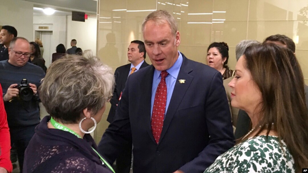 Newly sworn-in Interior Secretary Ryan Zinke, and his wife Lola, right, greets an Interior Department employee on the Interior Department's 168th birthday, March 3, 2017, at the Interior Department in Washington.