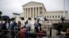 Members of the media report on the first day with newly sworn in Associate Justice Brett Kavanaugh on the court at the Supreme Court in Washington, Oct. 9, 2018. 