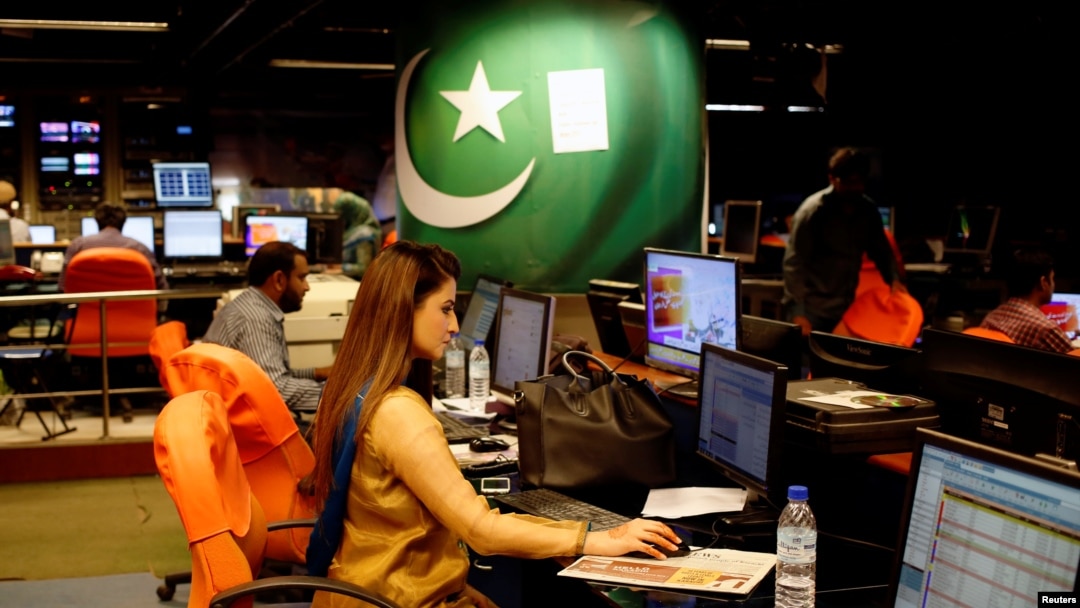 An employee works at the control room of the Geo News television channel in Karachi, Pakistan, April 11, 2018. 