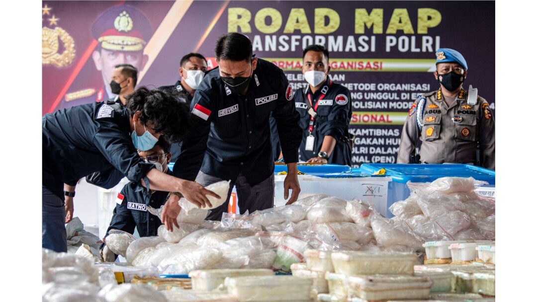 Indonesian police officers arrange drug evidence during a media conference, at the national police headquarters after officers managed to secure 2.5 tonnes of crystal methamphetamine from a network of the Middle East, Malaysia, and Indonesia, in Jakarta,