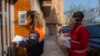 Felix Sesay works with a member of the civil emergency unit in Torrent, near Valencia. (Photo courtesy of Toni Tomas, Spanish Red Cross)